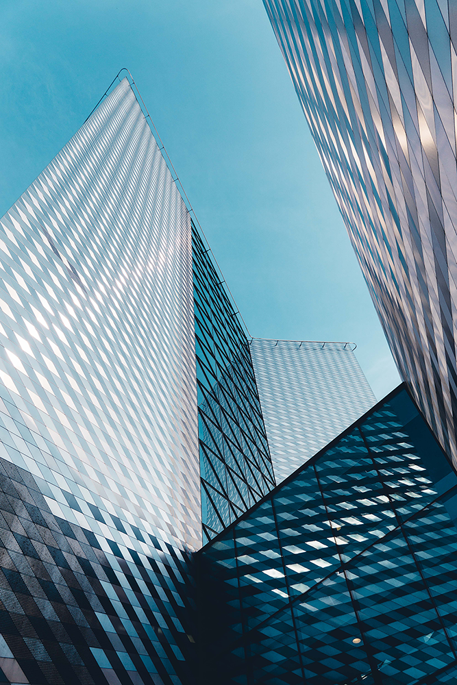 Looking up between two skyscrapers to a clear blue sky